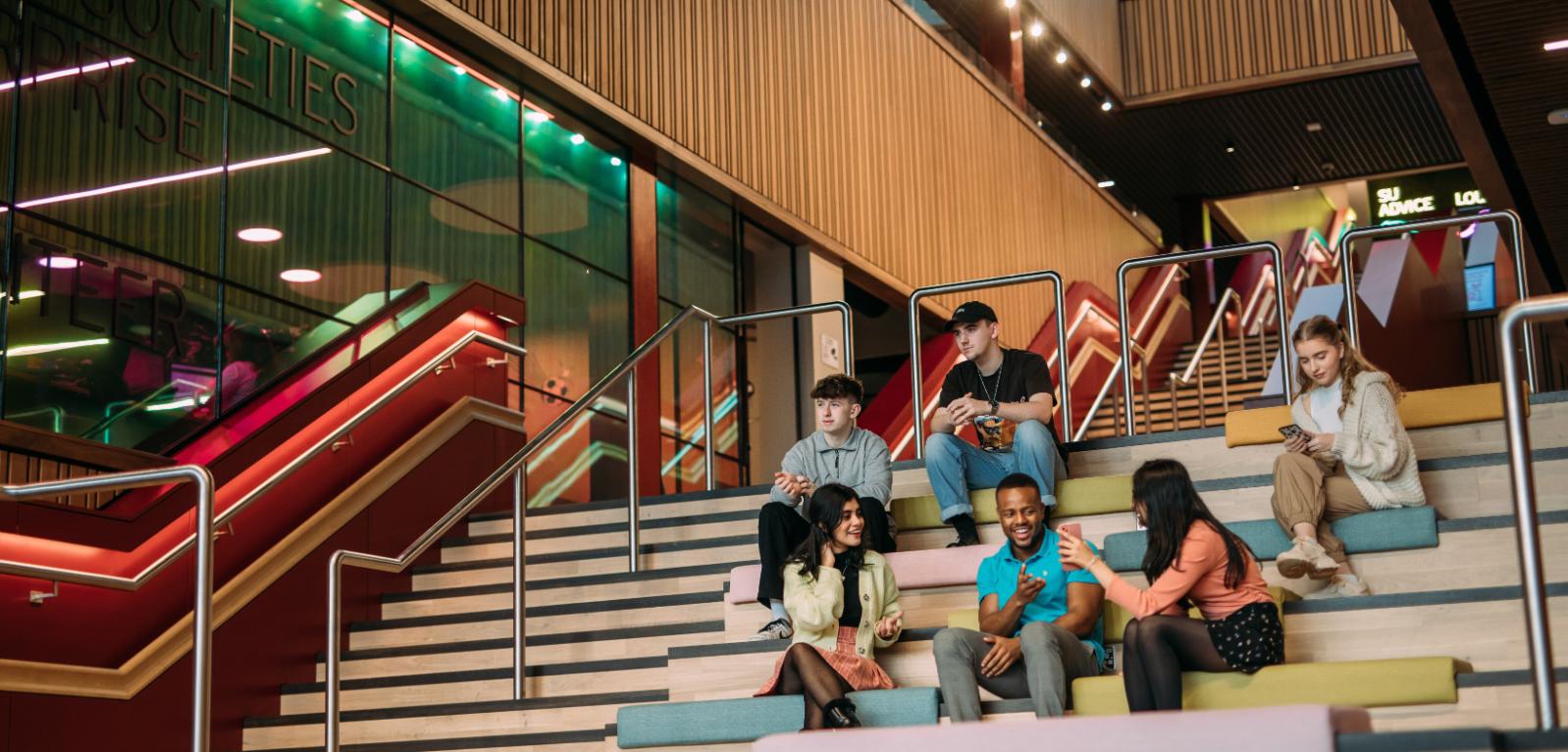 Students sitting on social stairs in Students' Union, One Elmwood