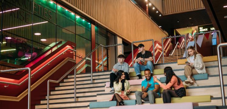 Students sitting on social stairs in Students' Union, One Elmwood